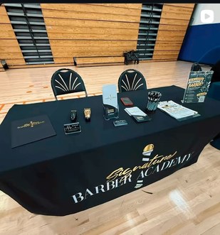 Signature Barber Academy recruiting table at an event
