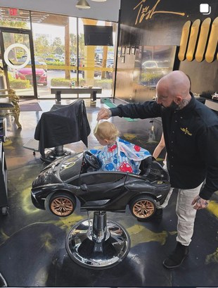 Tosh Juneau cutting a young client's hair