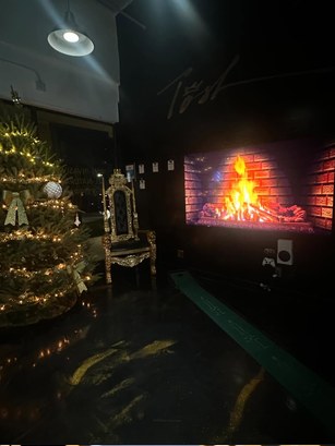 The shop lounge with a gold throne chair and fireplace screen