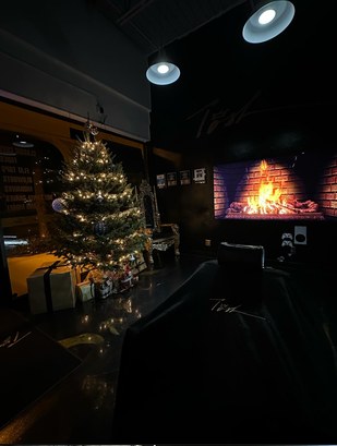 The shop at night with the holiday tree lit